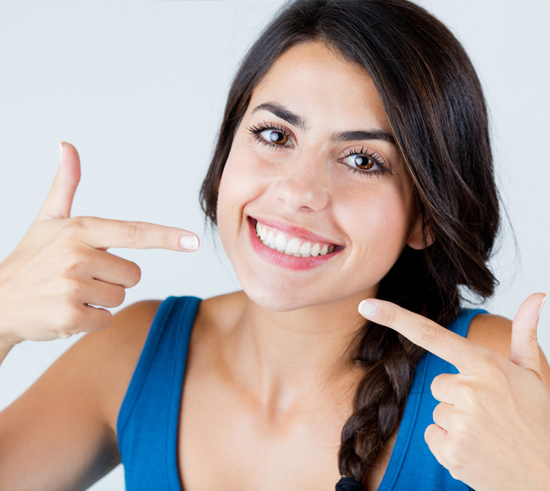 Girl showing her perfect smile after getting cosmetic dentistry at nearest dental care in Richmond Hill